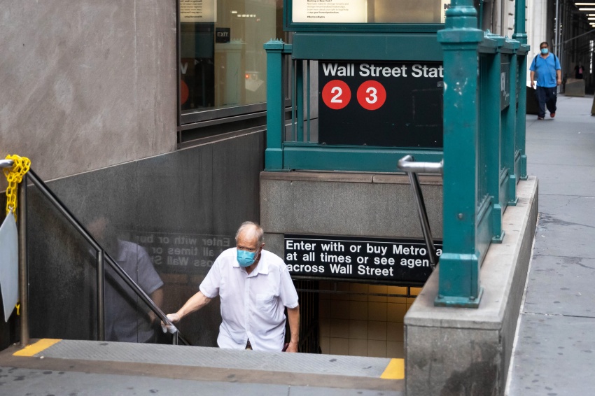 A pedestrian wearing a protective mask exits from the Wall Street subway station in New York, on Monday, July 20, 2020.